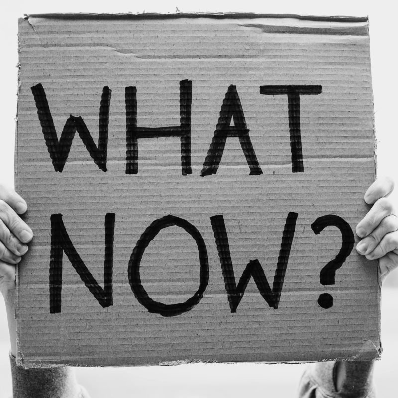 Hands Holding Banner with Question