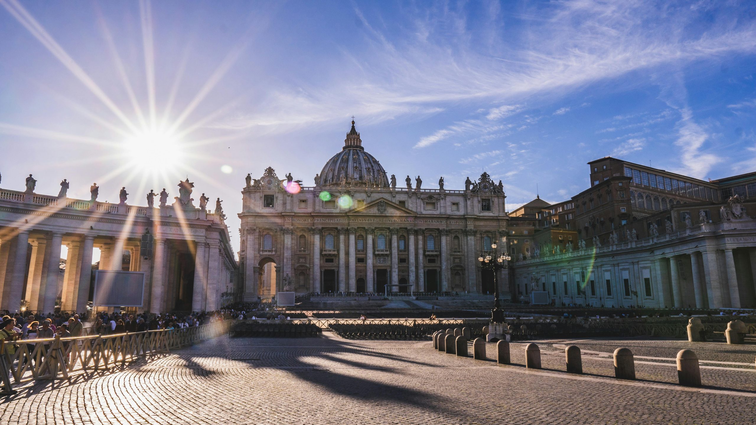 Stunning view of St. Peter's Basilica with sun rays, perfect for tourism and architecture themes.