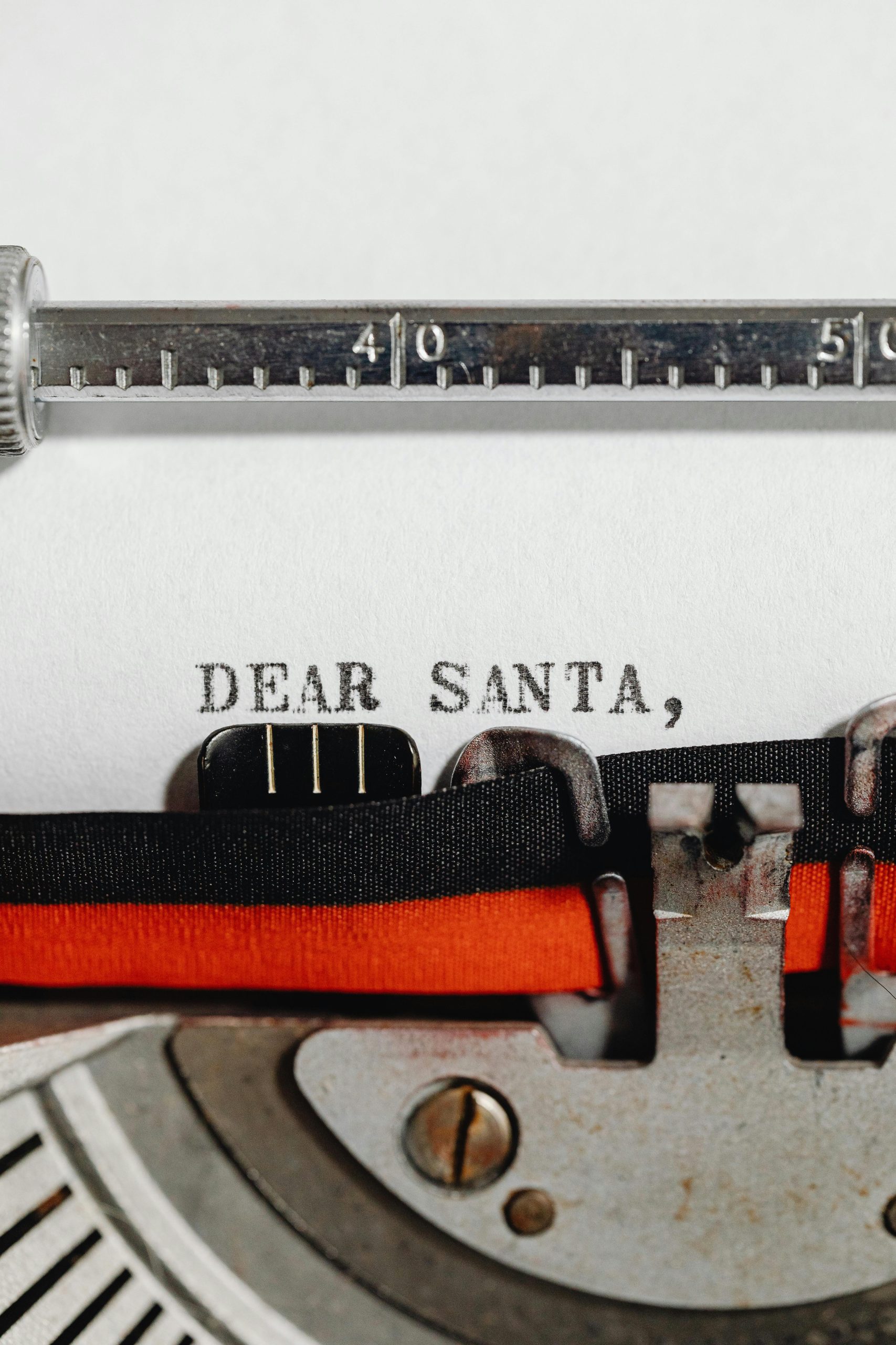 Close-up of a vintage typewriter typing 'Dear Santa,' on paper, capturing a festive and nostalgic holiday scene.