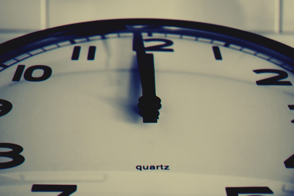 When Eight Seconds Isn't a Crisis: How Disciplined Brands Stay In Character Under Pressure Detailed close-up shot of a wall clock showing the hour hand at midnight, highlighting time concept.